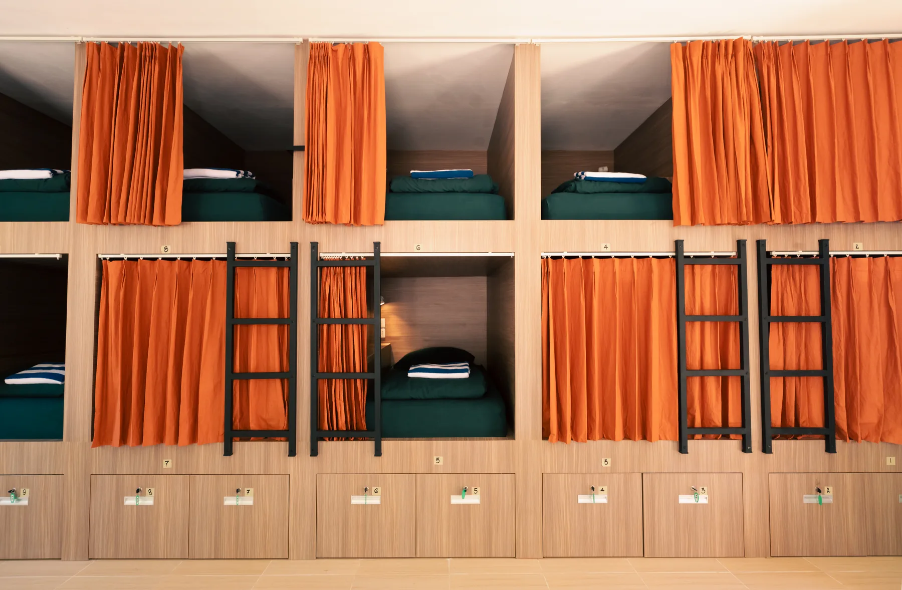Curtained pod beds in The Penida Project dorm