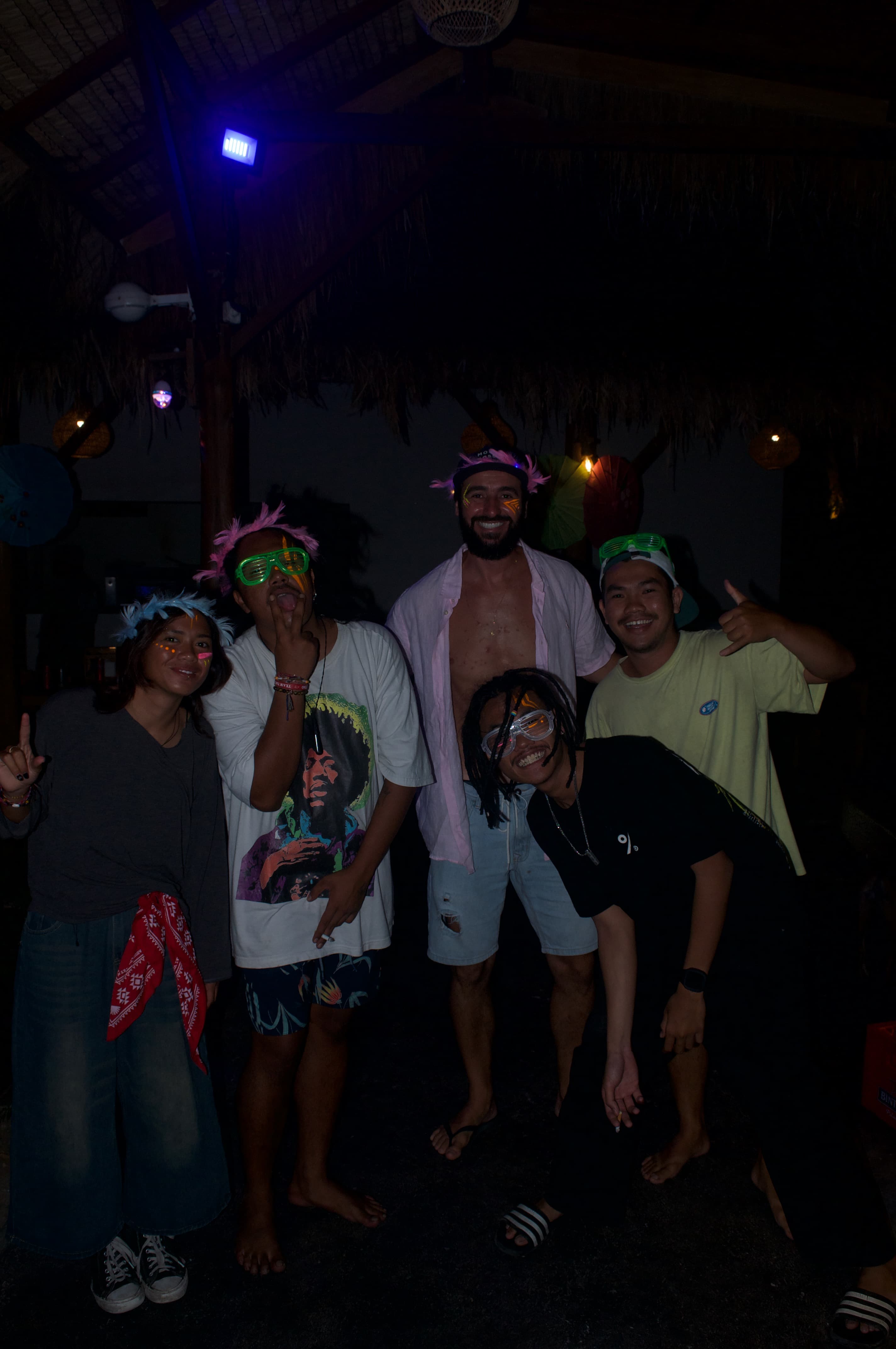 Friends wearing colourful Full Moon Party face paint at The Penida Project