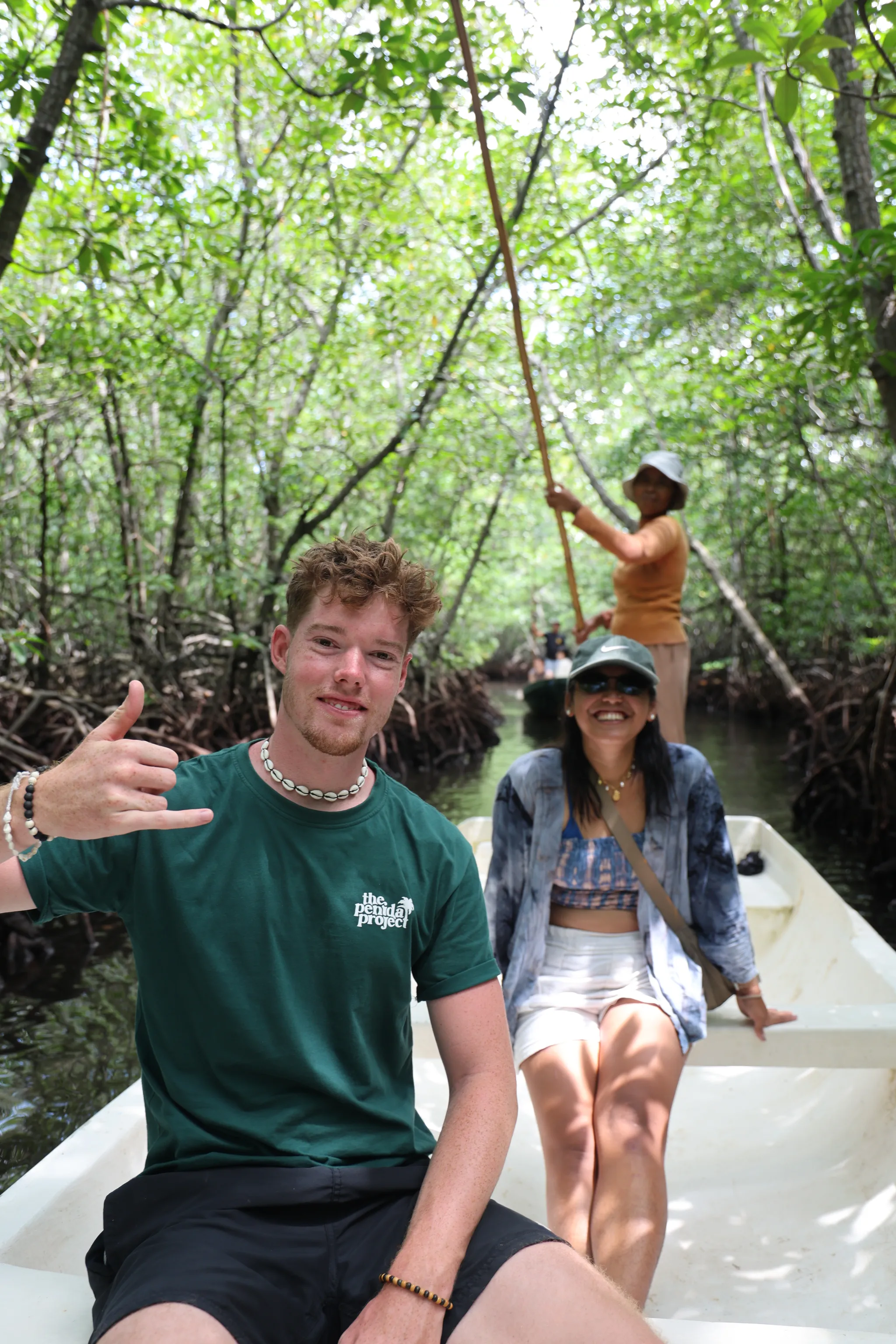 Guests travelling by boat through the mangrove forest