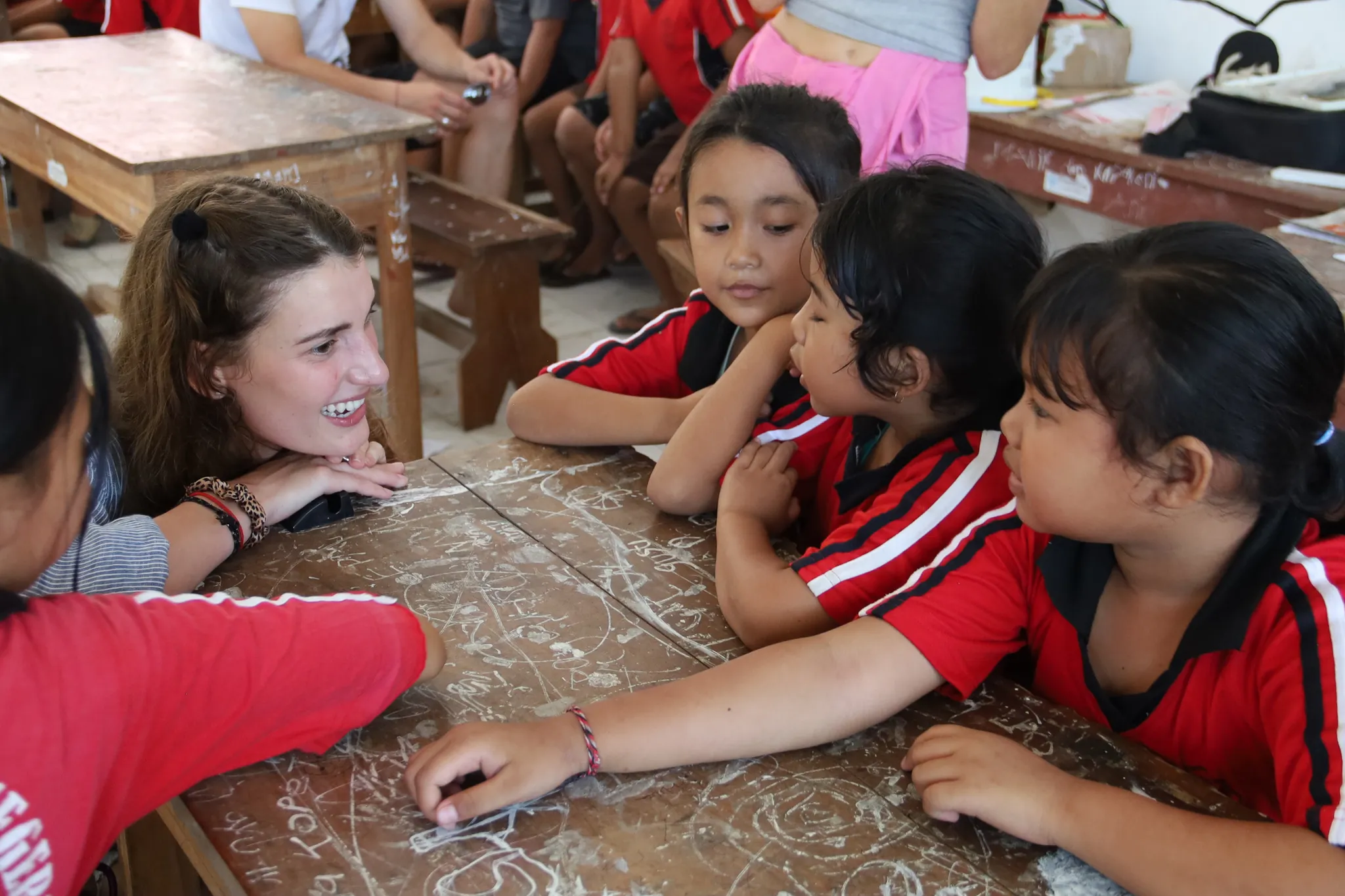 A guest joining a table activity with students