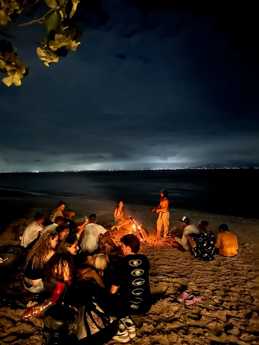 Backpackers enjoying a beach bonfire social night in Nusa Penida, Bali
