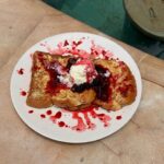 French toast topped with mixed berry compote and vanilla ice cream served poolside at The Penida Project in Nusa Penida
