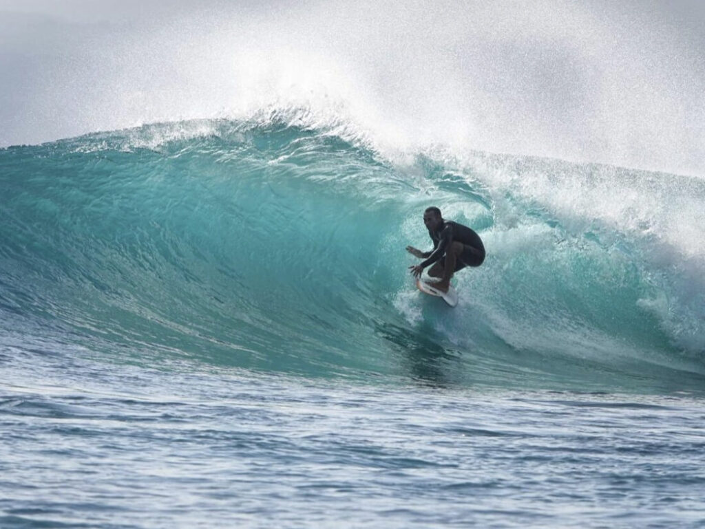 Surf instructor Dollar riding a barrelling wave at Nusa Lembongan, coach at We Surf