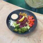 Rainbow Buddha bowl with purple sweet potato, chickpeas, broccoli, tomato and tahini dressing at The Penida Project in Nusa Penida.