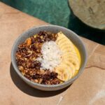 Poolside smoothie bowl at The Penida Project in Nusa Penida topped with fruit, granola and coconut flakes